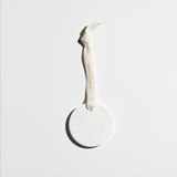 Mystic Bliss scented white ceramic ornament with embossed design and hanging ribbon